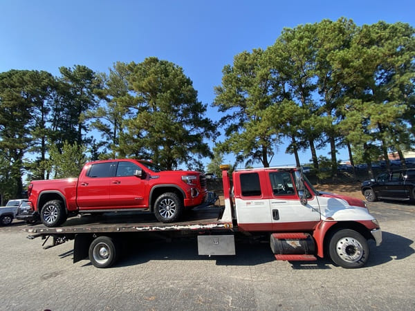Tow truck hauling a car on the road